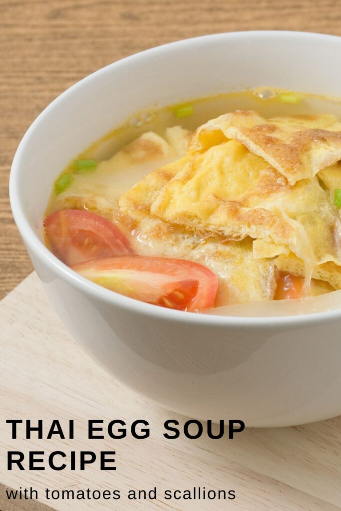 Thai Egg Soup with fresh tomatoes in a white bowl