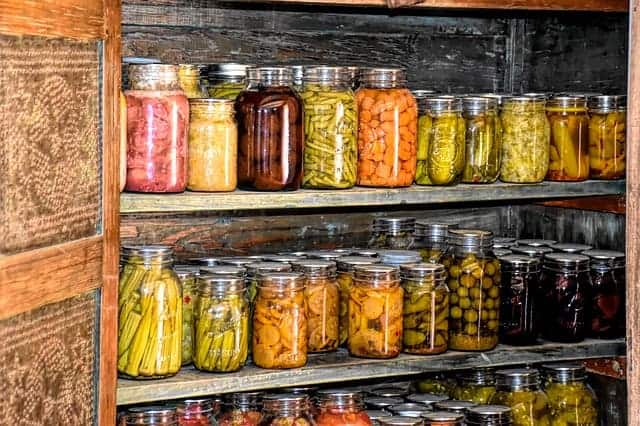 canned vegetables on shelves of root cellar