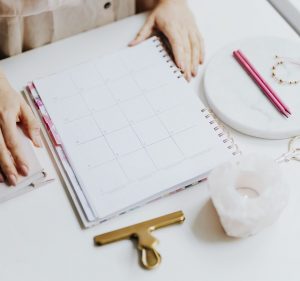 person sitting at table with agenda to organize themselves