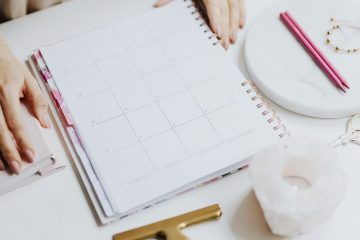 person sitting at table with agenda to organize themselves