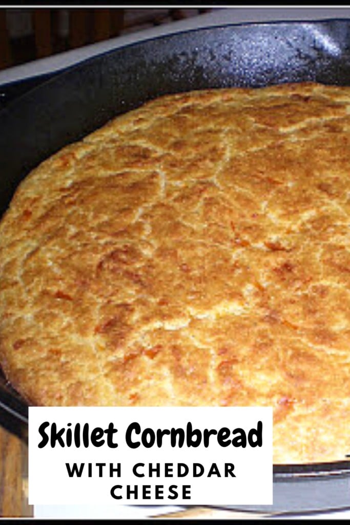 homemade cornbread in a cast iron skillet with text overlay 'Skillet Cornbread with Cheddar Cheese'