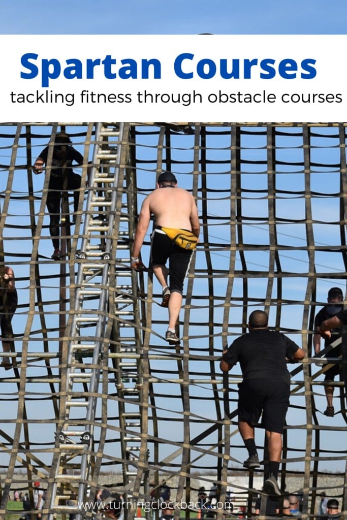 people climbing obstacle course with text Spartan Courses tackling fitness through obstacle courses