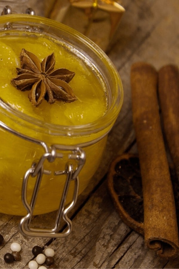 Orange marmalade and spices on a wood cutting board