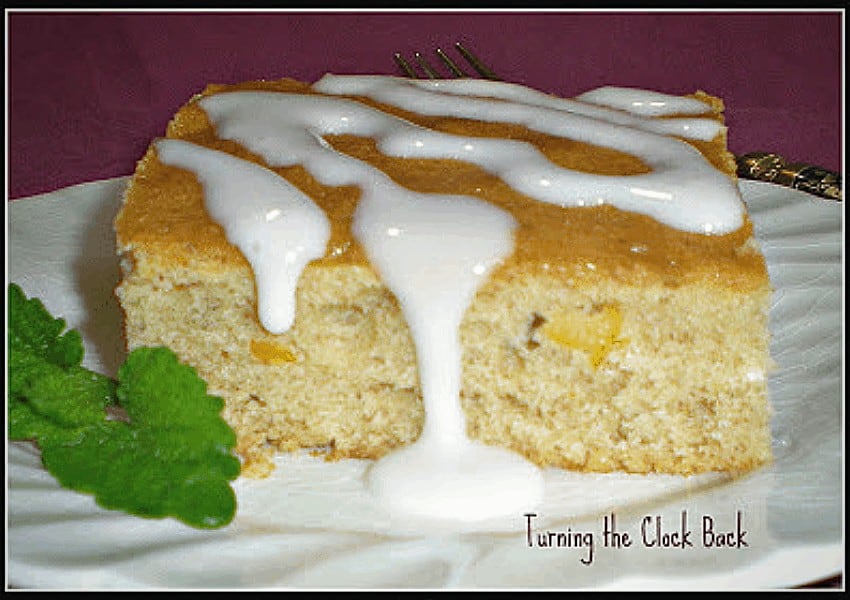 Orange marmalade cake with lemon icing on a white plate