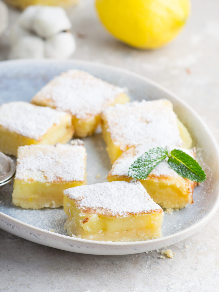 classic lemon bars with shortbread crust on a white plate