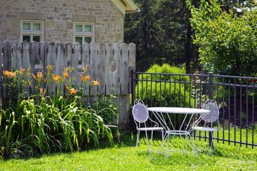 backyard with table, flowers and grass