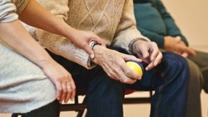 elderly people sitting and doing therapy