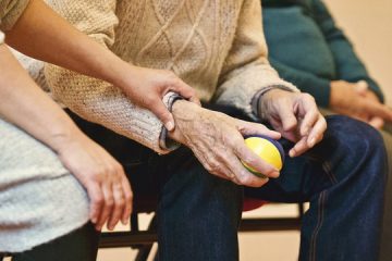 elderly people sitting and doing therapy