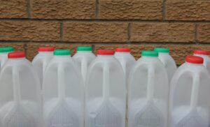 group of empty plastic milk containers