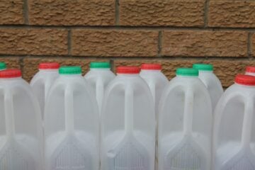 group of empty plastic milk containers