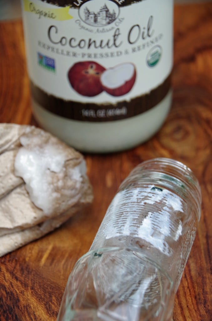 empty spice jar next to coconut oil being used to remove its lable