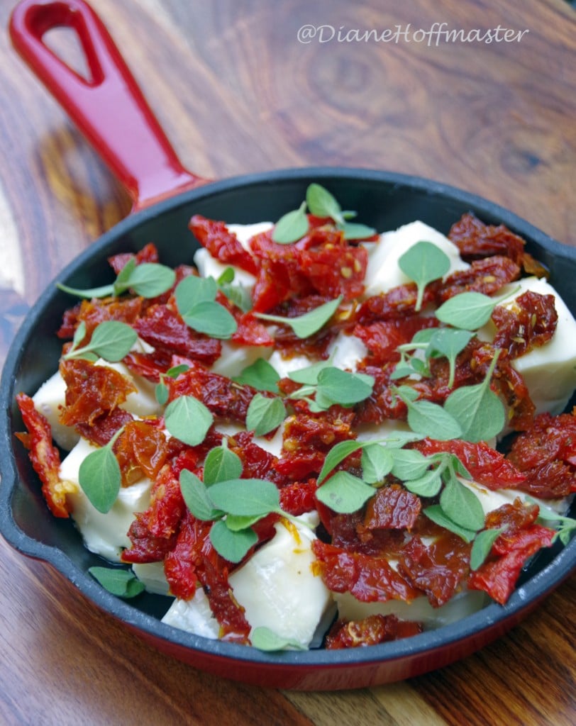 brie, sun dried tomatoes and oregano in a small cast iron pan