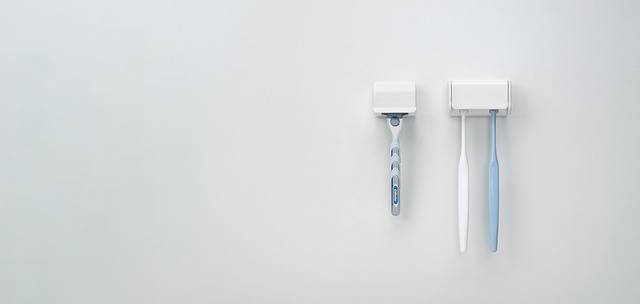 Toothbrushes and razor stored on wall