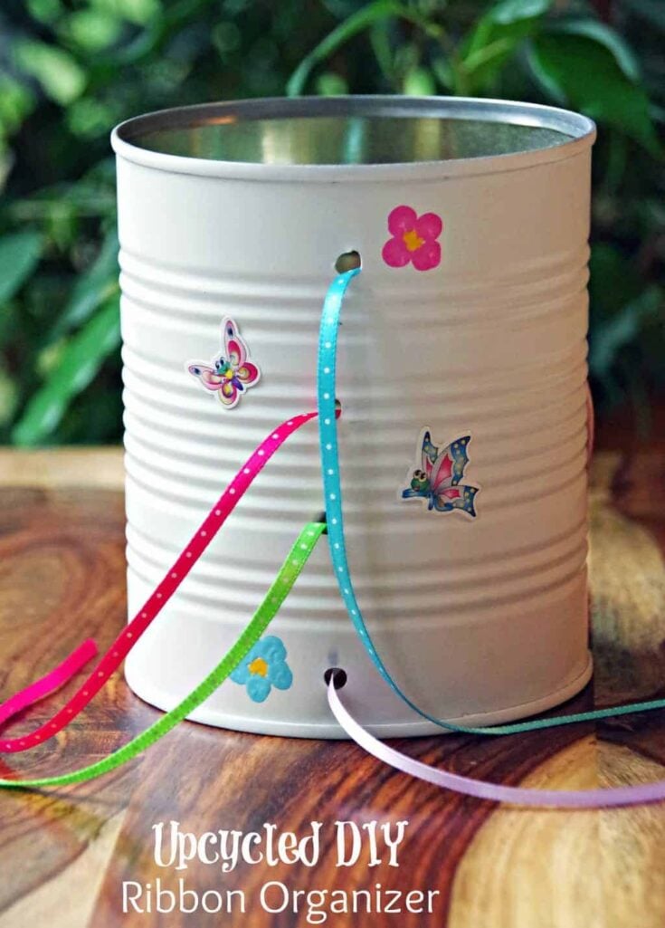 tin can upcycled into ribbon organizer with thin ribbon in it