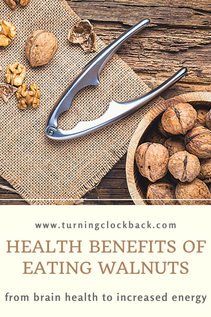 bowl of walnuts in shell with nut cracker and text overlay "Health Benefits of Eating walnuts"