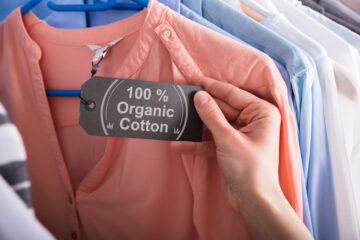 Woman Holding Label Showing 100 Percent Organic Cotton