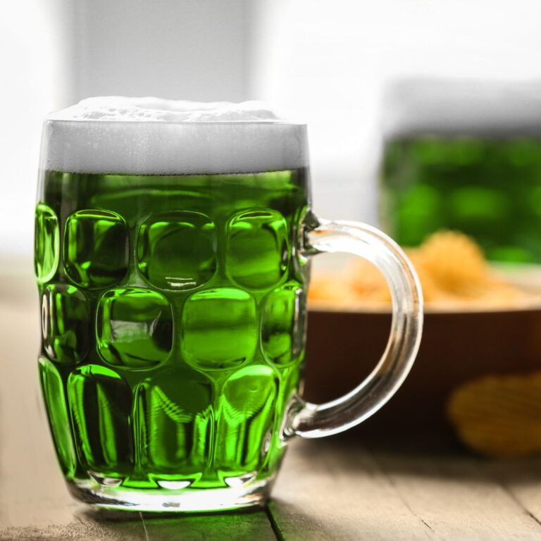 green beer in front of a bowl of potato chips