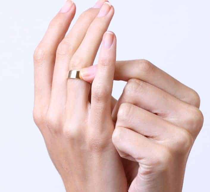 Sustainable wedding band being placed on woman's hand