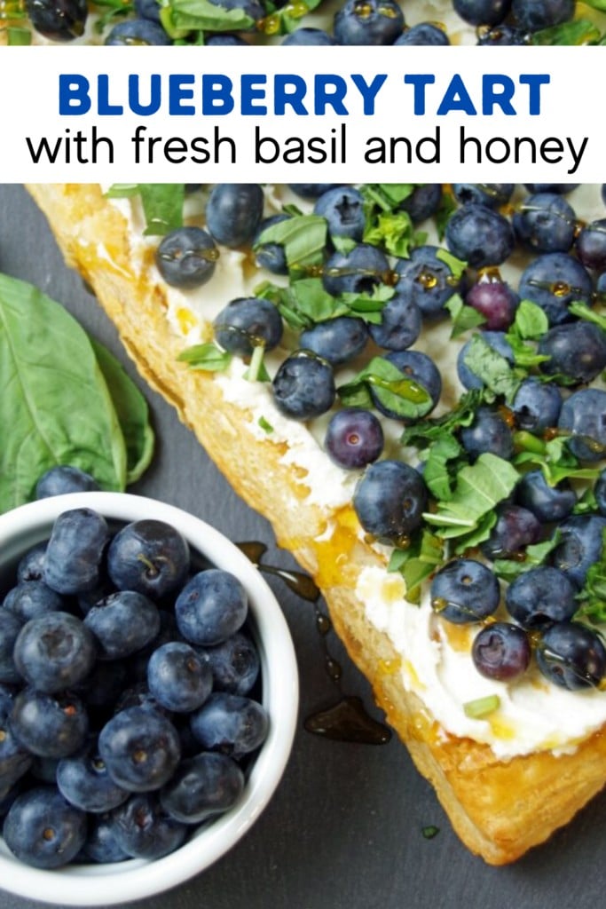 blueberry tart with bowl of fresh blueberries and fresh basil 