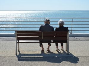 older couple sitting on bench