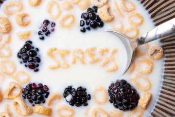 A bowl of alphabet cereal pieces floating in milk with the word STRESS spelled out.