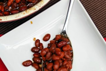 New England Style Homemade Baked Beans from Scratch in a ceramic pot with metal spoon