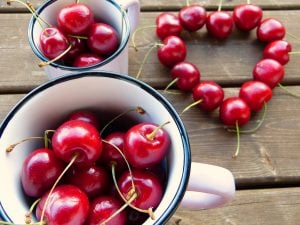 cherries in a mug and in the shape of a heart