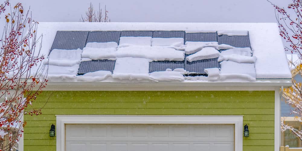 Solar panels on snow covered roof in winter. 