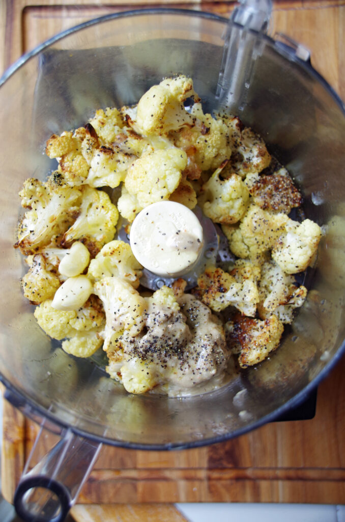 Roasted cauliflower in food processor with garlic, tahini, lemon juice and olive oil for cauliflower hummus