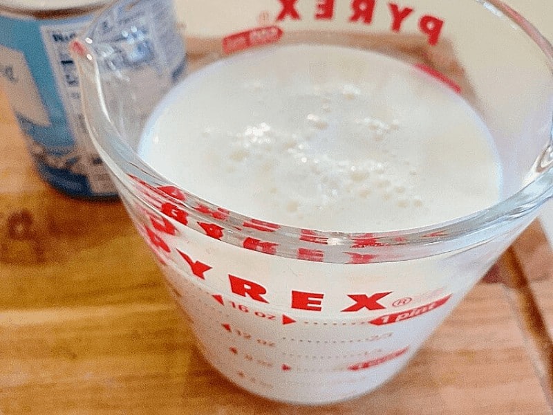Whole milk in glass measuring cup