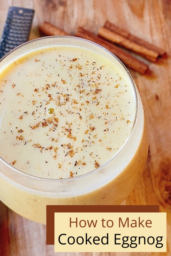 cooked eggnog in a glass on a wooden cutting board