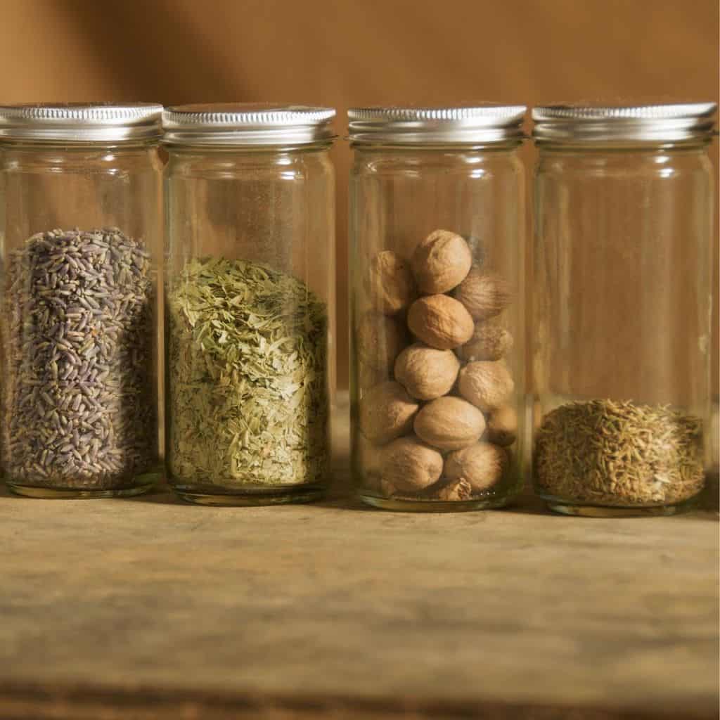 Jars of old spices on cutting board