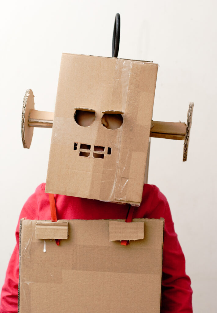 Robot Girl. Little girl with a cardboard box on herhead.