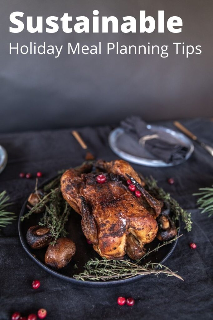 roasted chicken on a table with natural decor and text overlay 'sustainable holiday meal planning tips'