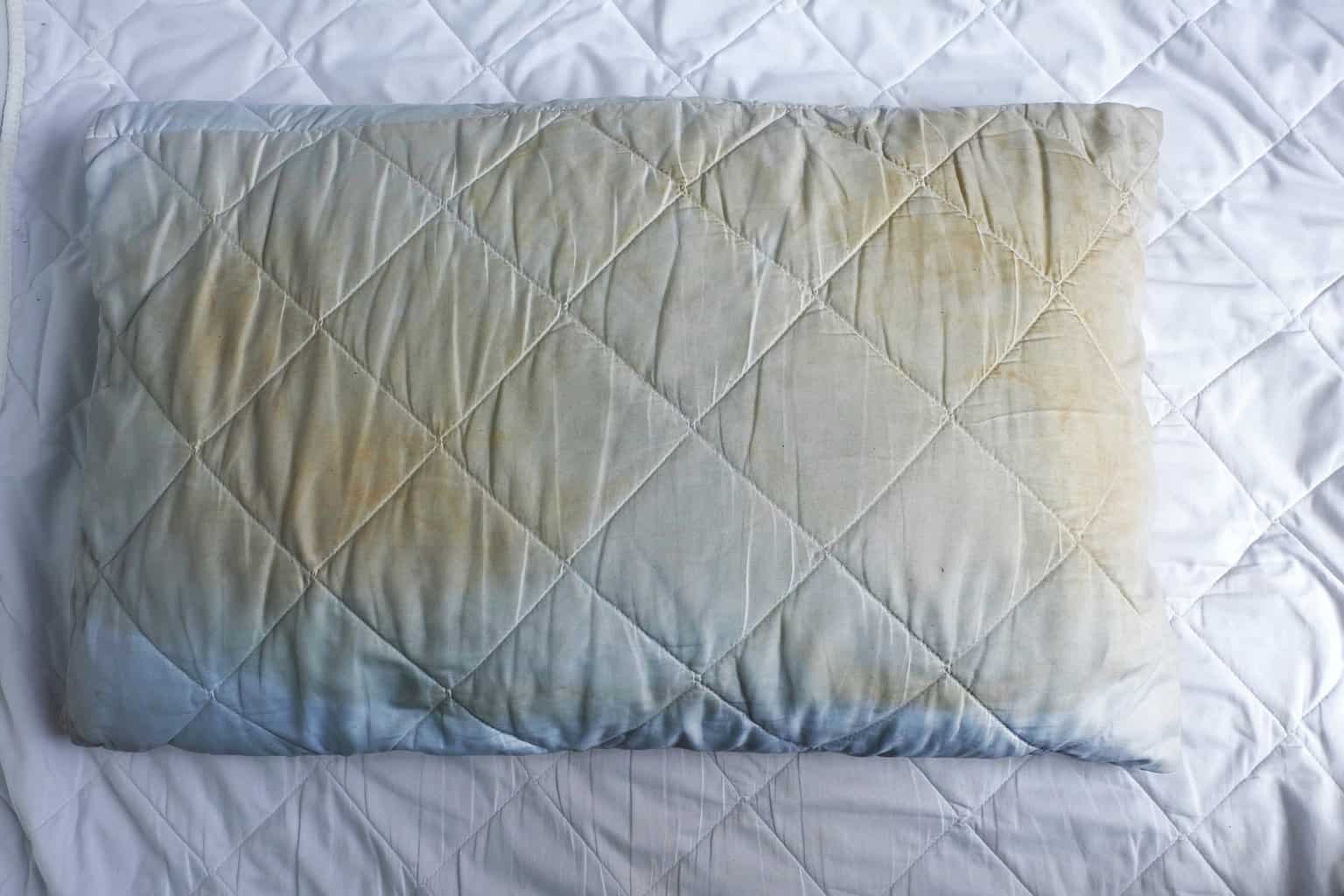old stained pillow on bed