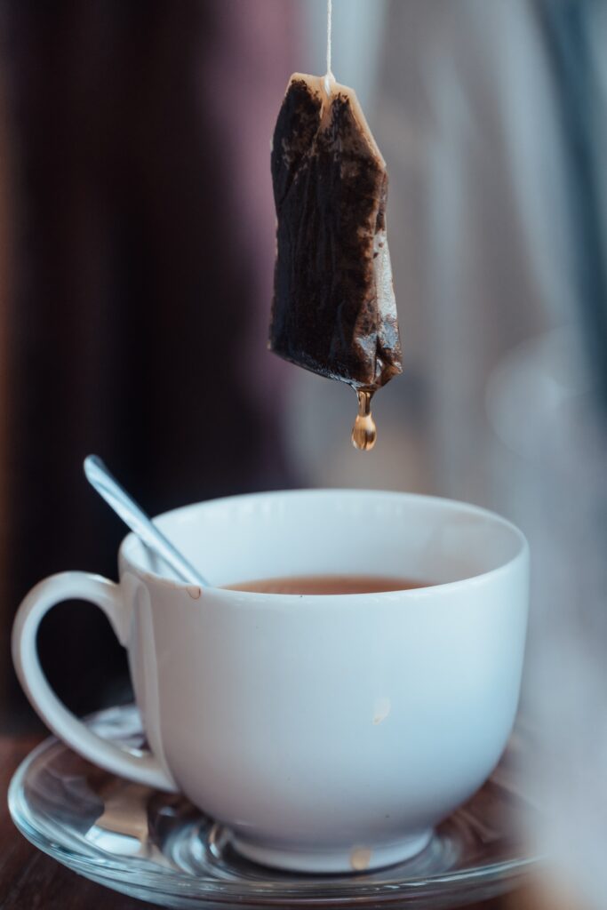 closeup of tea bag over a tea cup