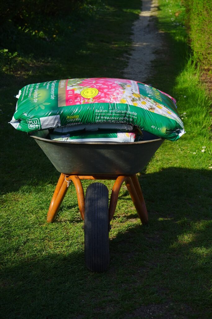 wheel barrow with bags of soil on it