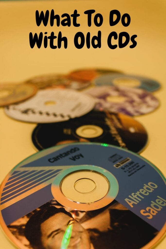 old cds on a yellow background with text overlay 'What To Do With Old CDs'